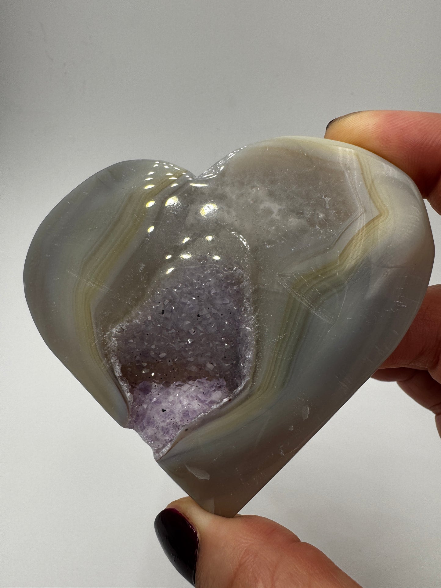 Großformatiges herzförmiges Carving aus violettem Amethyst und gebändertem Achat, B-Ware mit seitlicher Beschädigung.