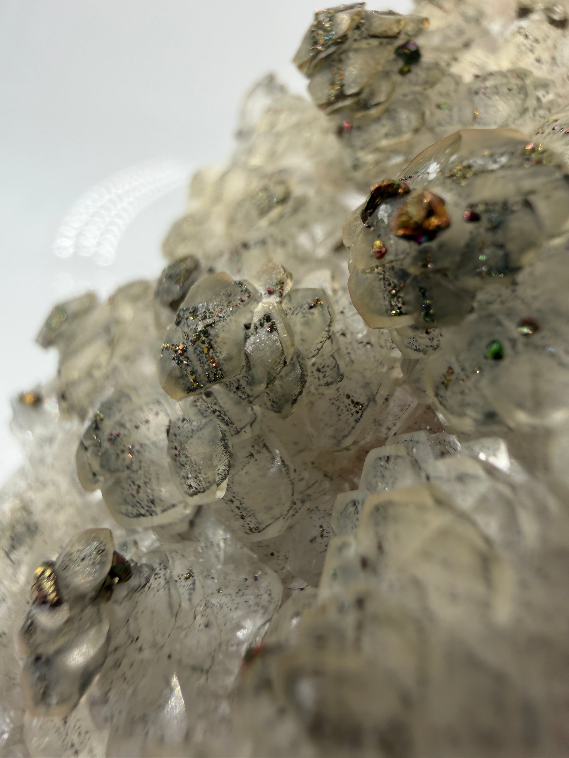 Weißer Calcit mit goldglänzenden Pyrit-Kristallen auf Gesteinsmatrix aus Herdringen, Sauerland.