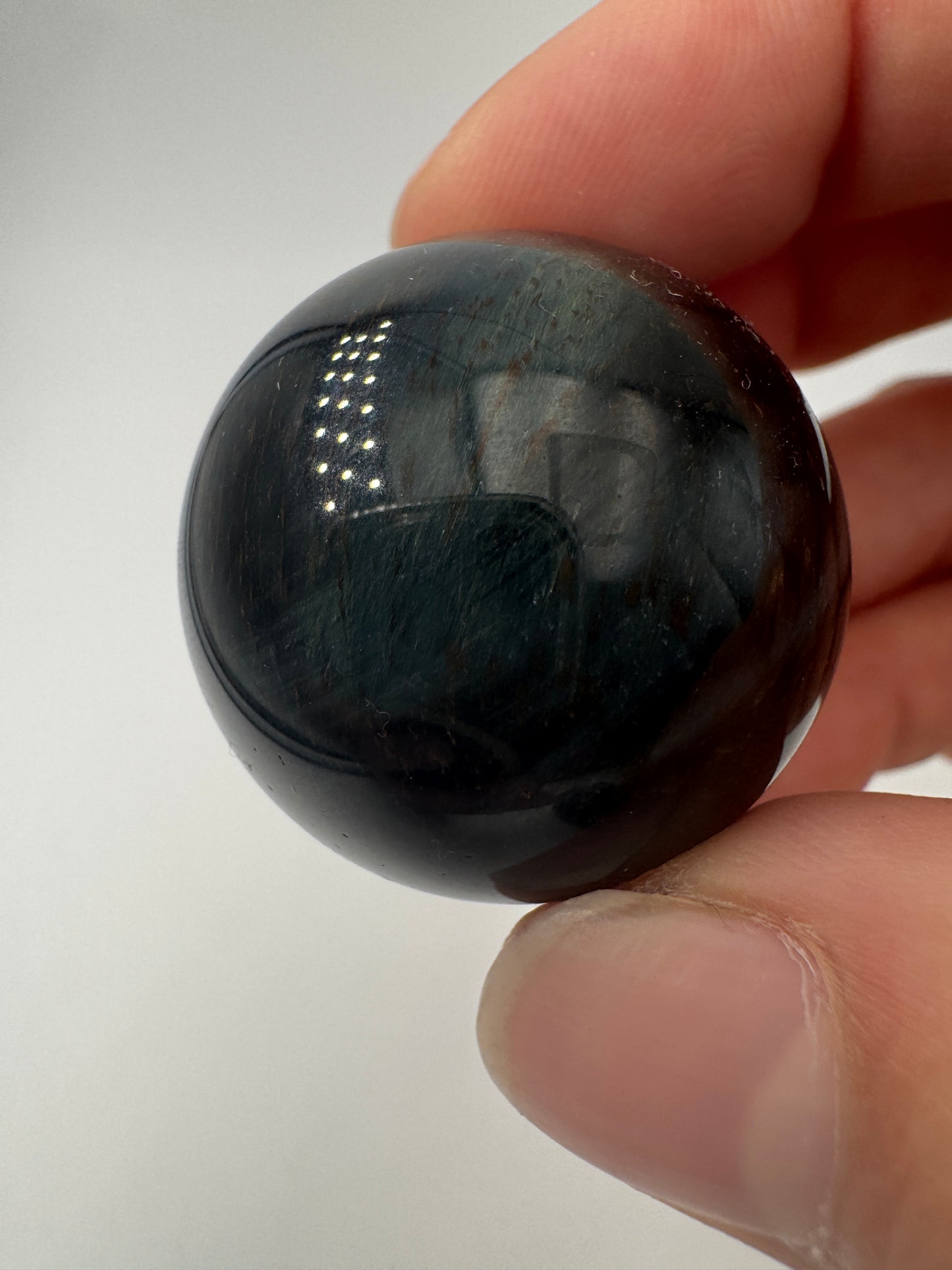 Falkenauge-Kugel, Ø 2,6–2,9 cm – polierte Quarz-Sphäre in Blaugrau mit charakteristischem Chatoyance-Effekt (Seidenglanz), mineralogisches Sammlerobjekt.