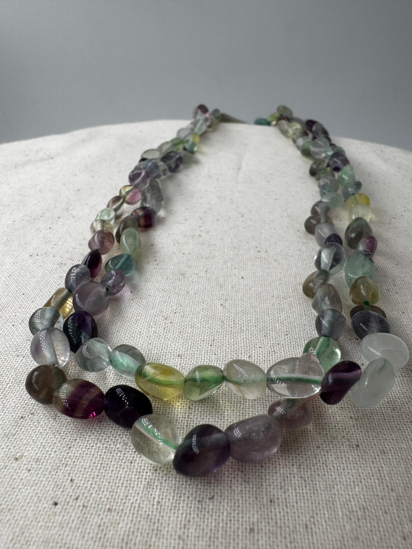 Fluorit-Kette mit violett-grünem Stein und natürlicher Maserung.