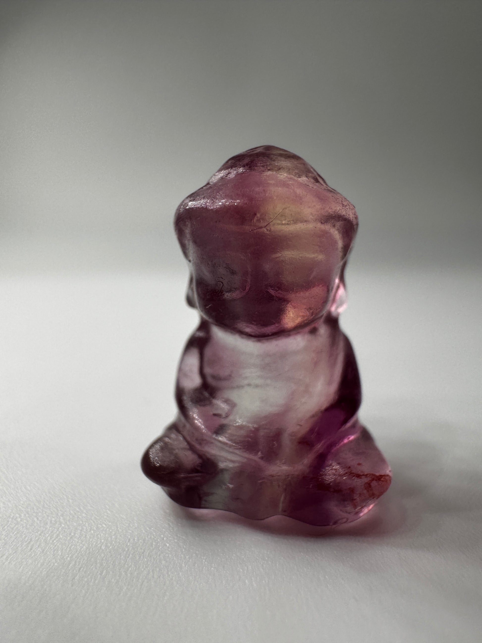 Miniatur-Buddha aus Fluorit FB3 mit glasartigem Glanz, erhältlich in Rosa, Lila, Lila-Blau und Gelb-Lila.