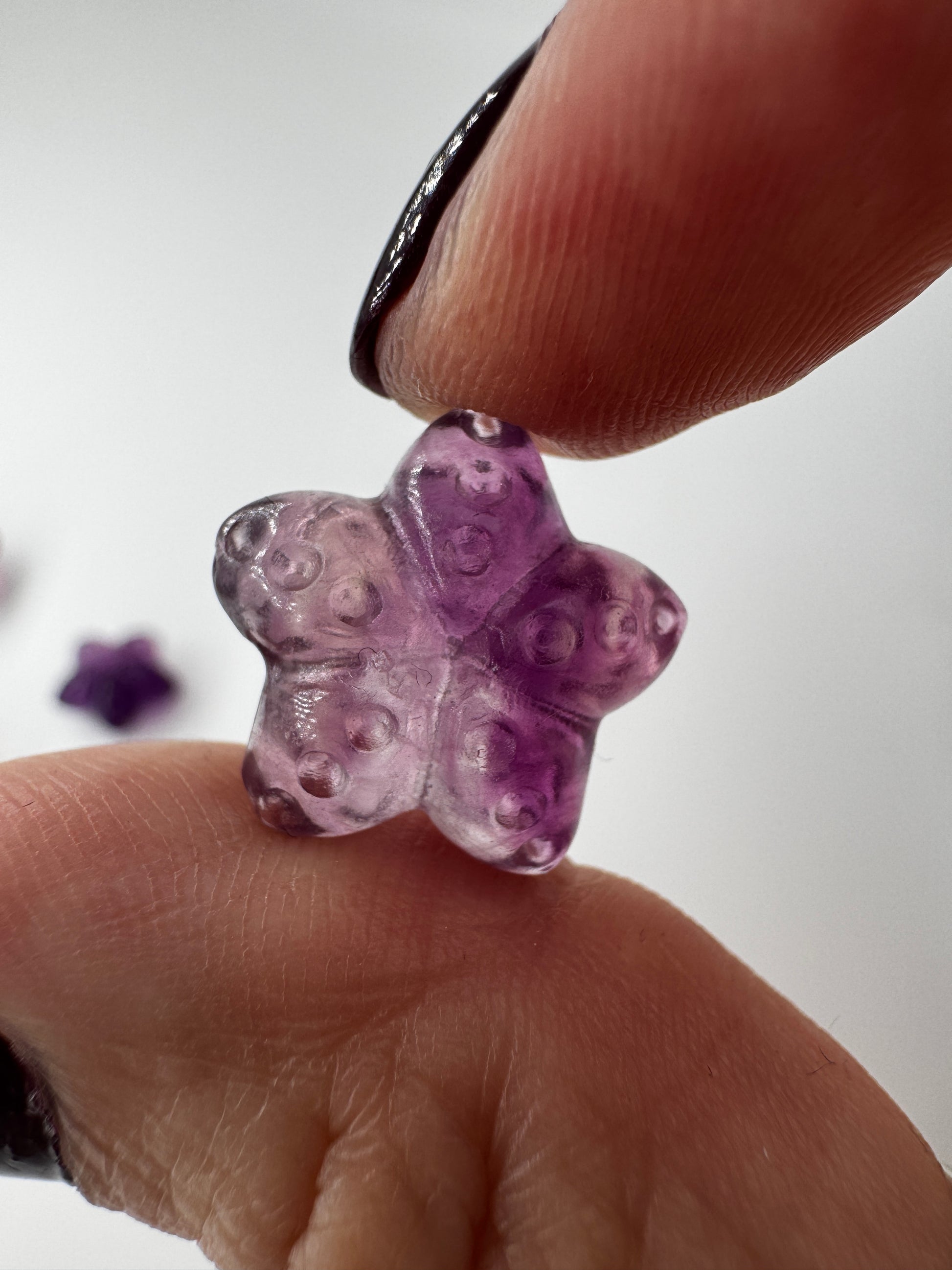 Miniatur-Seestern aus Fluorit FS3 mit glasartigem Glanz in Rosa.