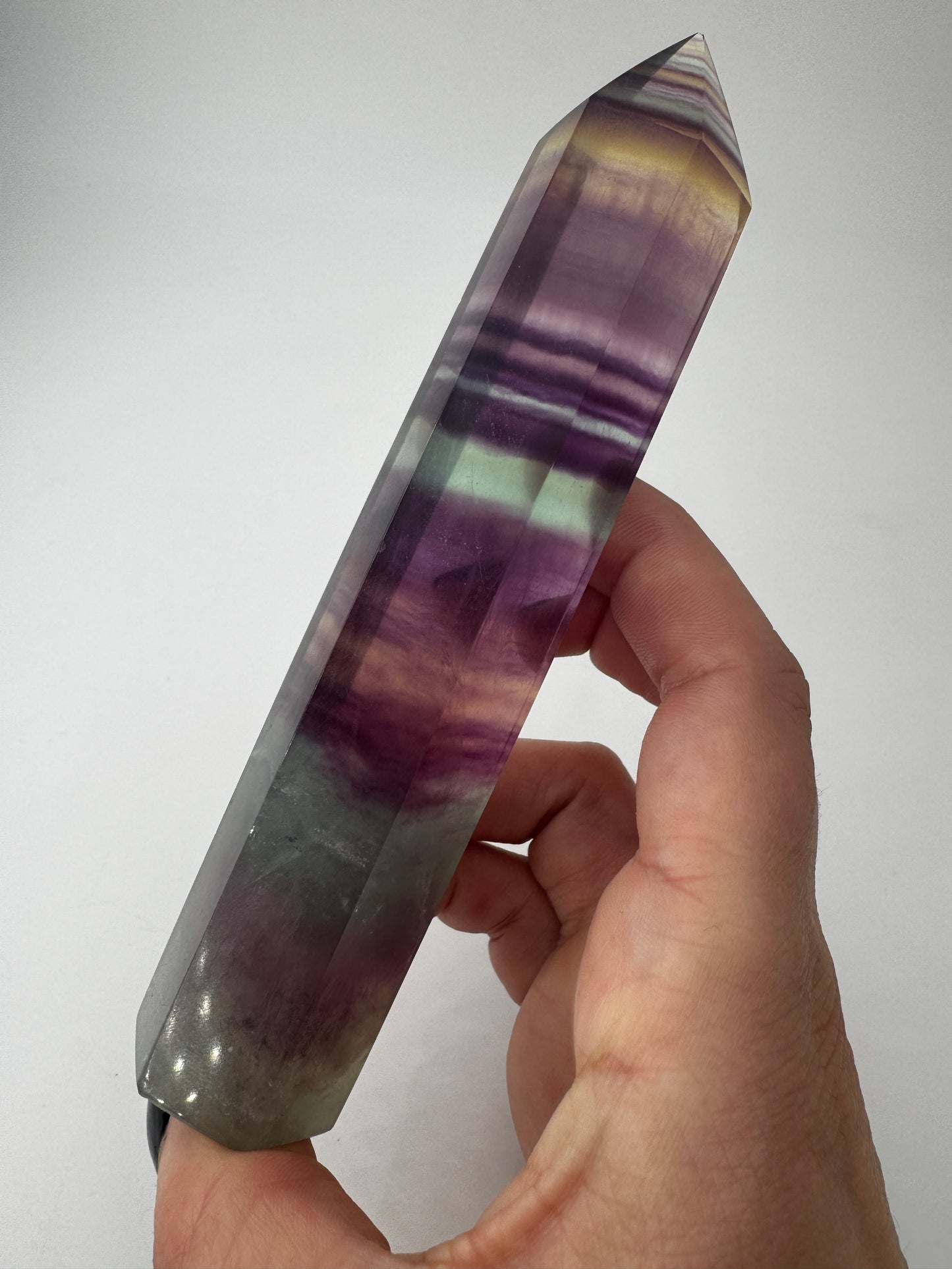 Geschliffene Fluorit-Spitze in Turmform mit natürlichem Farbspiel, Höhe 14,5 cm.
