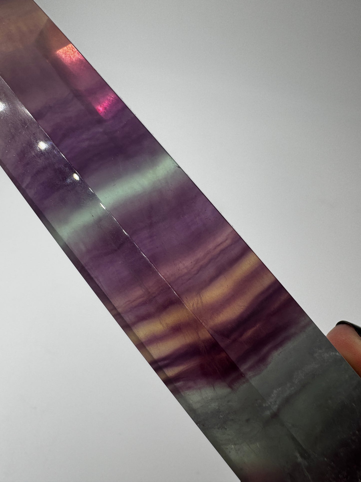 Geschliffene Fluorit-Spitze in Turmform mit natürlichem Farbspiel, Höhe 14,5 cm.