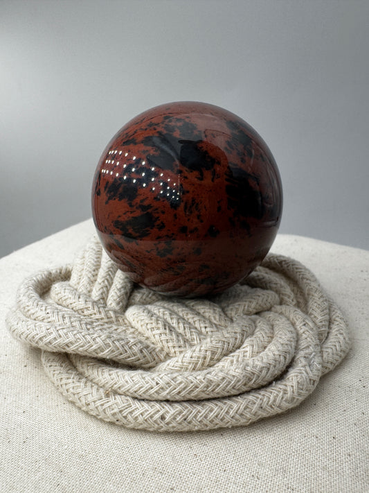 Polierte Kugel aus Mahagoni Obsidian mit rotbraun-schwarzer Maserung, Durchmesser 5,6 cm.