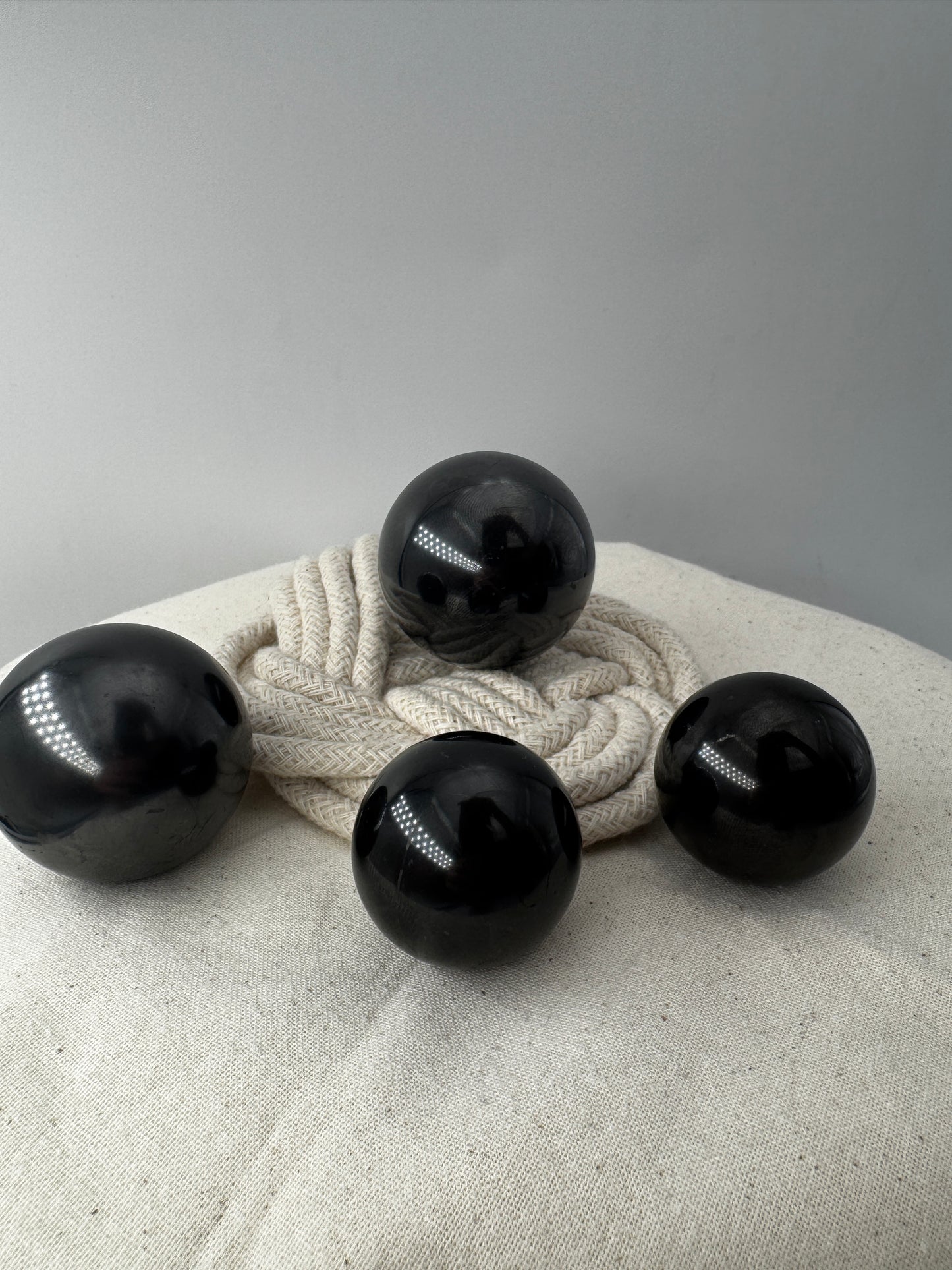 Eine perfekt runde, tiefschwarze Kugel aus poliertem Shungit.