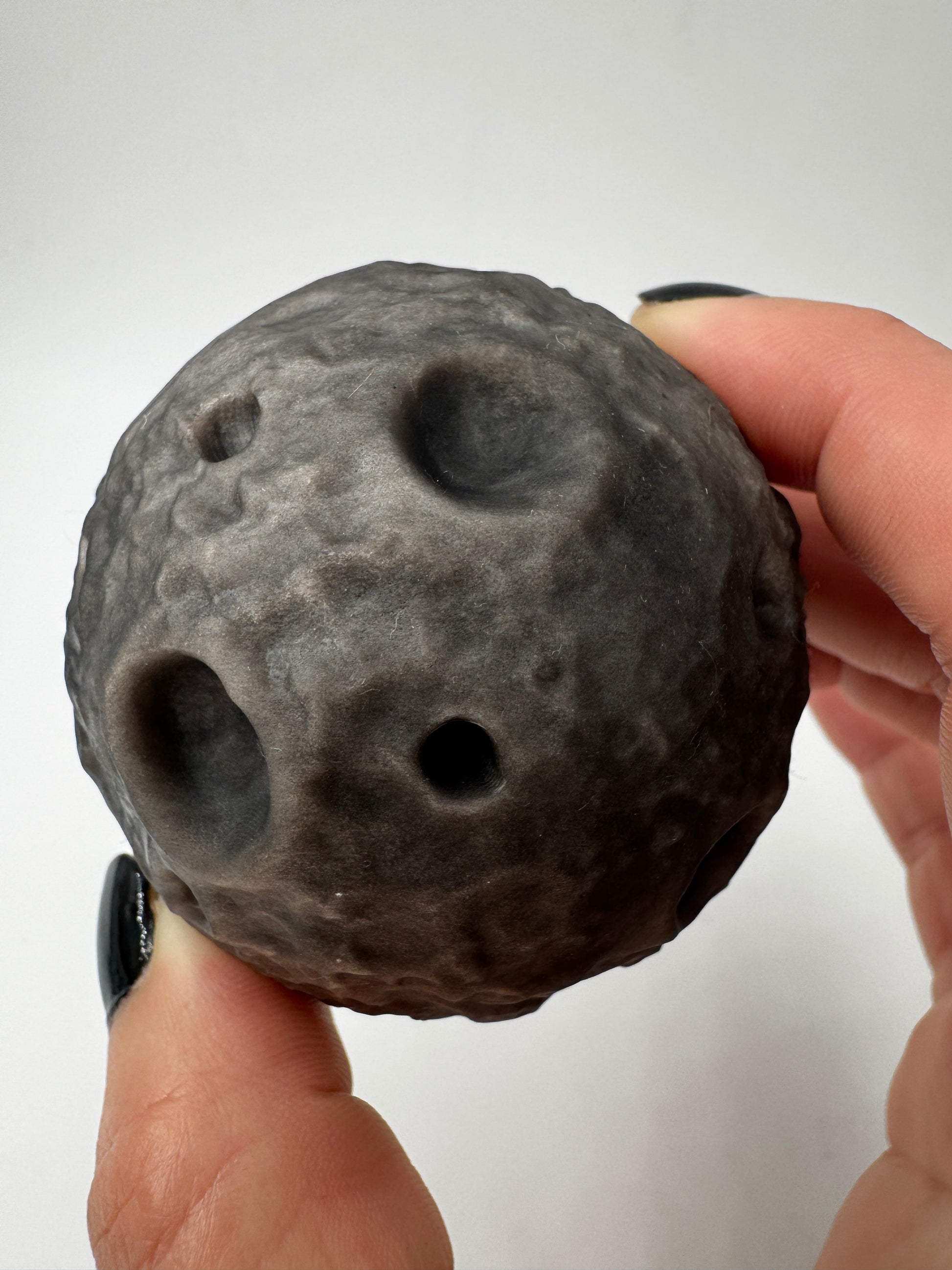 Silber-Obsidian-Mond mit haptischen Kratern und silbrigem Chatoyance-Effekt.